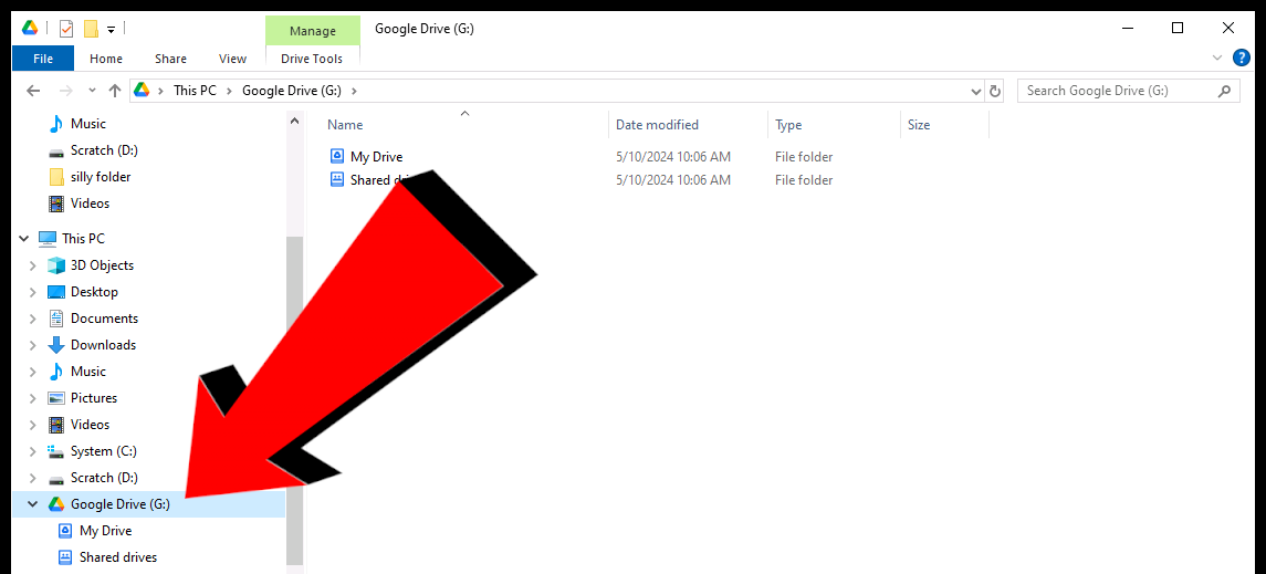 A screenshot of the Windows file explorer, with a big red arrow pointing towards the "Google Drive" drive in the "This PC" dropdown menu.